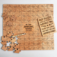 Wooden puzzle guest book with signed pieces, an engraved center piece, a wooden pen and the guest sign