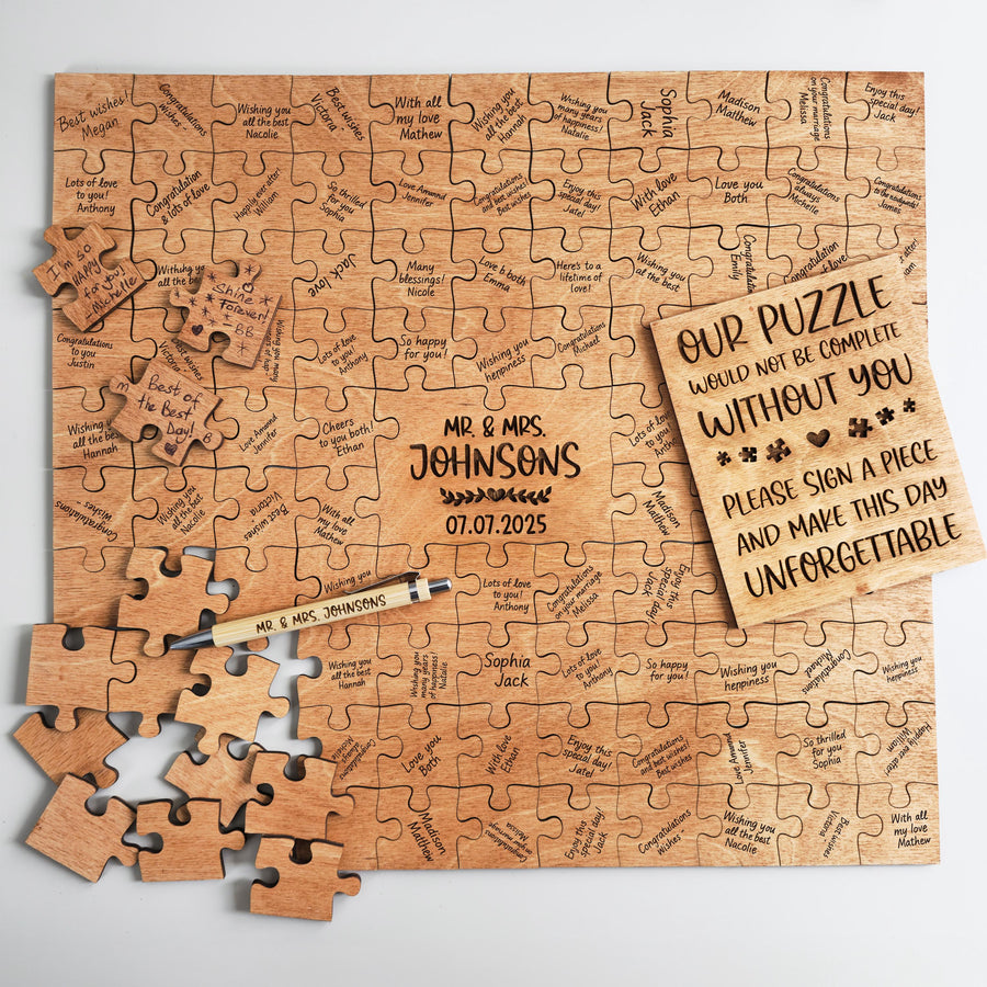Wooden puzzle guest book with signed pieces, an engraved center piece, a wooden pen and the guest sign