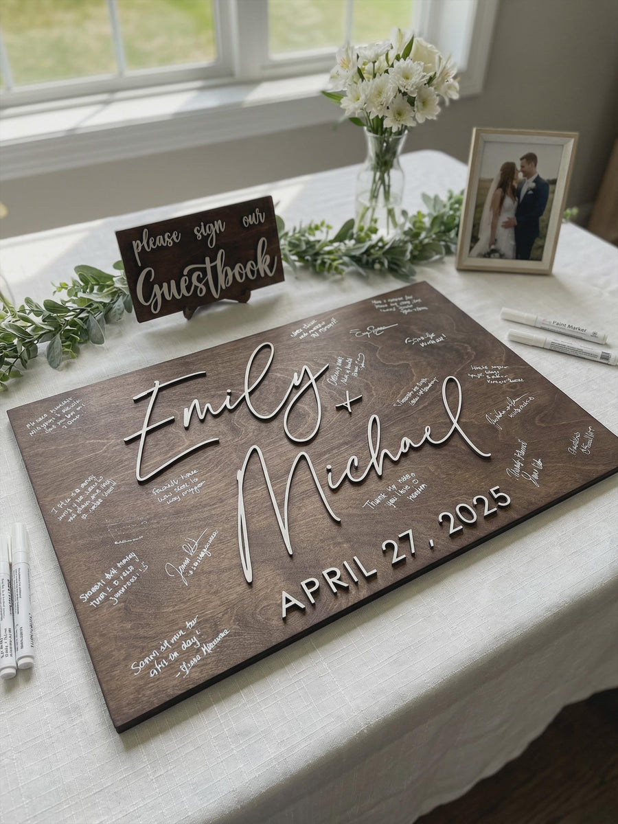 Signed personalized wood guestbook sign on wedding table, rustic 3D wedding guest book alternative with custom names, date, white message signatures, and please sign our guestbook sign.