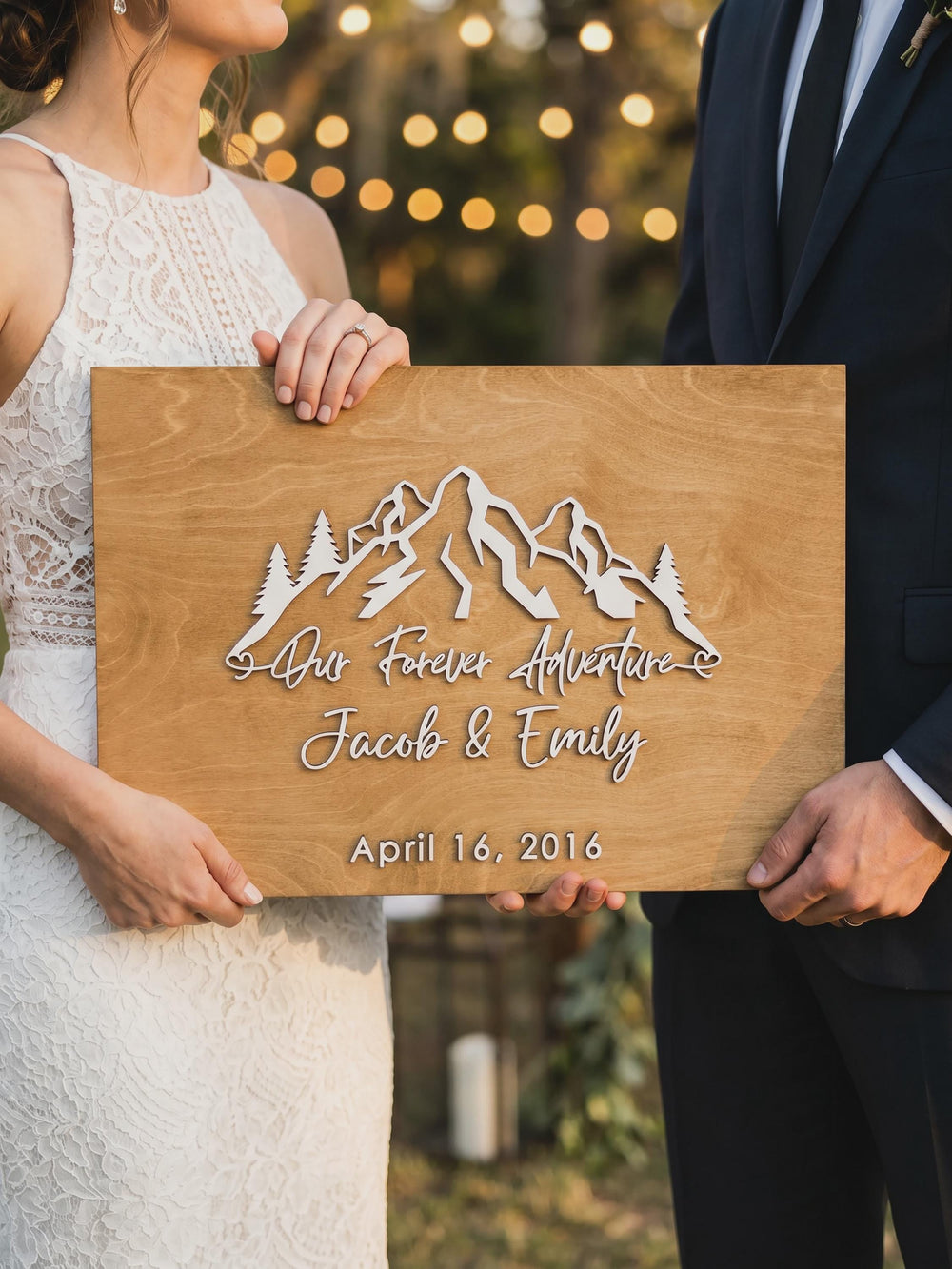 Forest mountain guest book sign with the couple's names and date in raised letters.