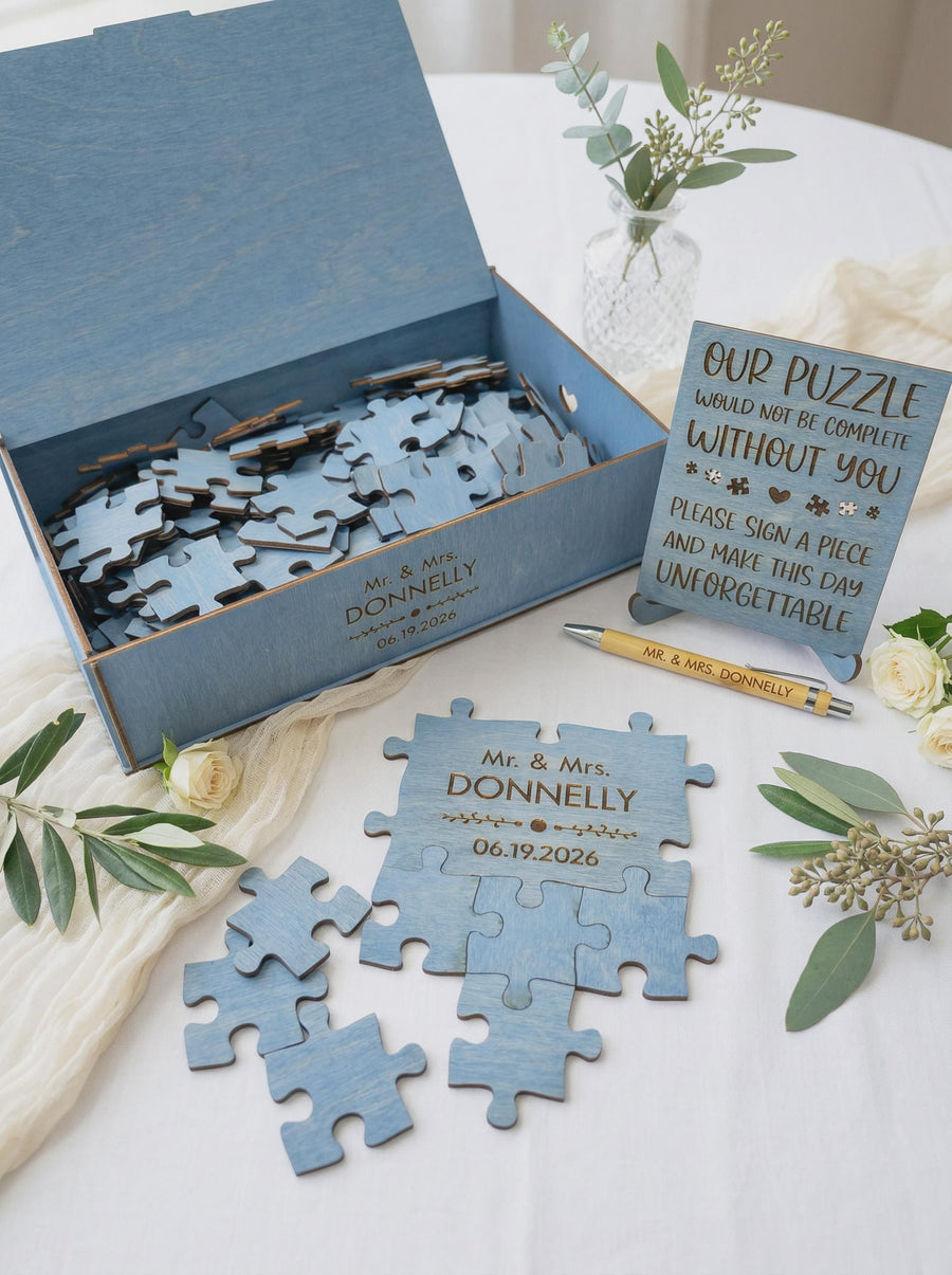 Ocean blue puzzle guest book set on a wedding table: puzzle, matching box, engraved pen and the guest sign