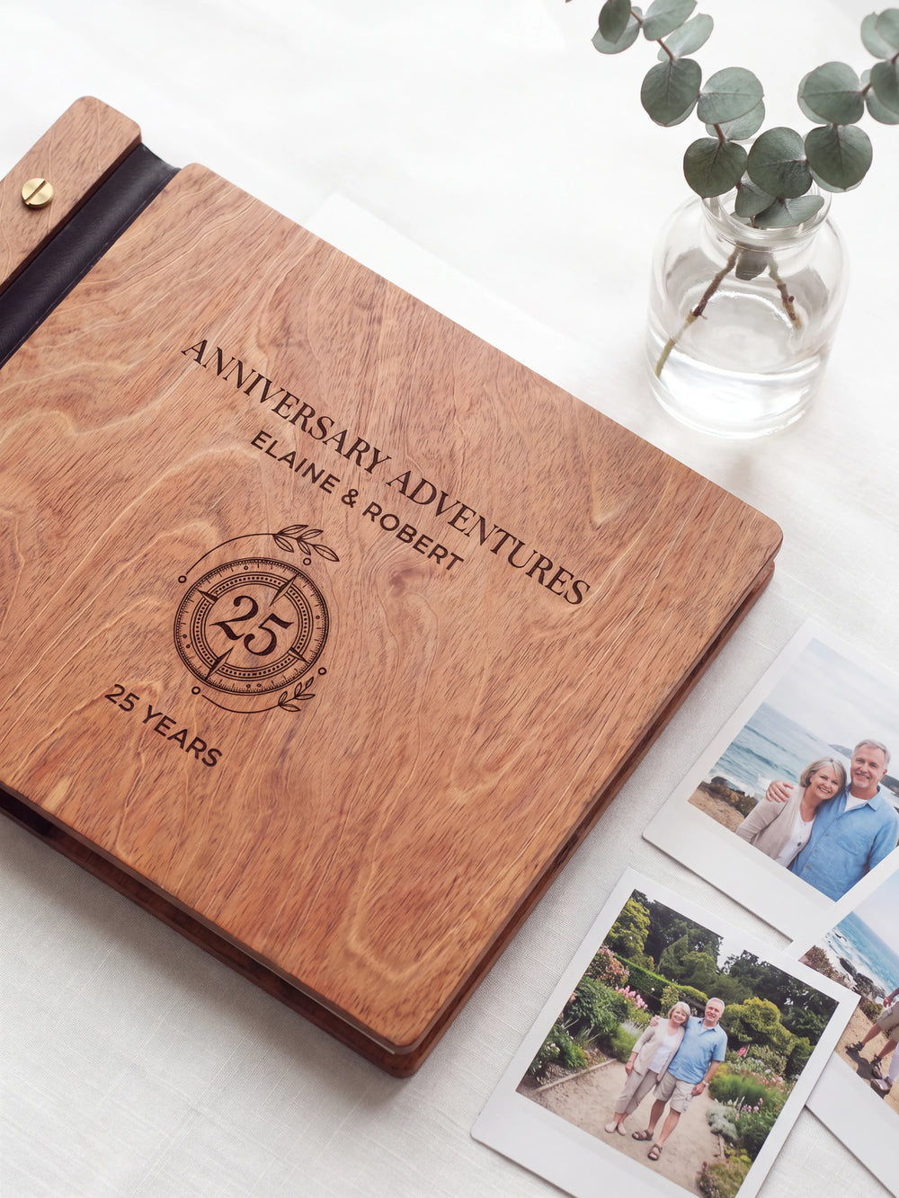Close-up of a circular 25-year anniversary emblem engraved in dark brown on the Hazelnut wooden cover, showing the fine artwork and surrounding wood grain.