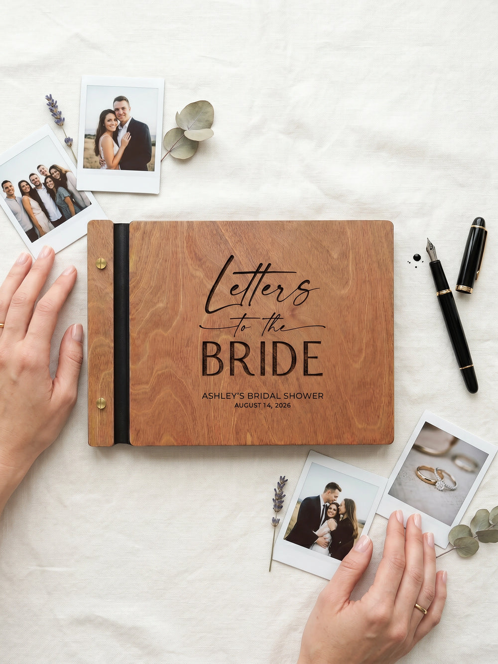Hazelnut wood Letters to the Bride photo guest book engraved Ashley's Bridal Shower August 14, 2026, on a white cloth with instant photos, a pen and lavender