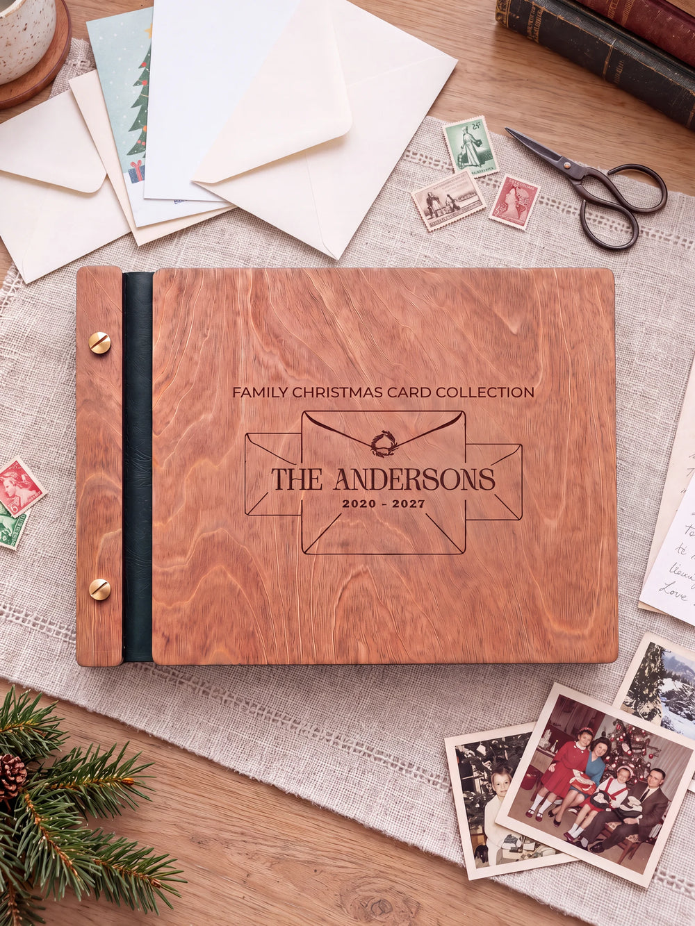 The full Hazelnut FAMILY CHRISTMAS CARD COLLECTION album cover is shown close up. Brown engraved artwork, personalized wording, the narrow binding and gold screws are visible.