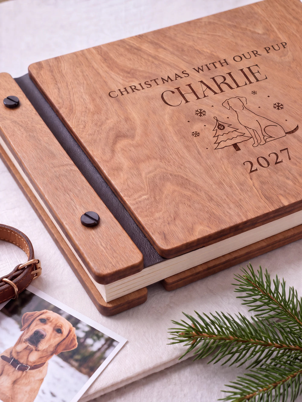 Close view of the Hazelnut album’s brown engraving, binding and black screw heads. Cream page edges and separate wooden cover sections are visible.