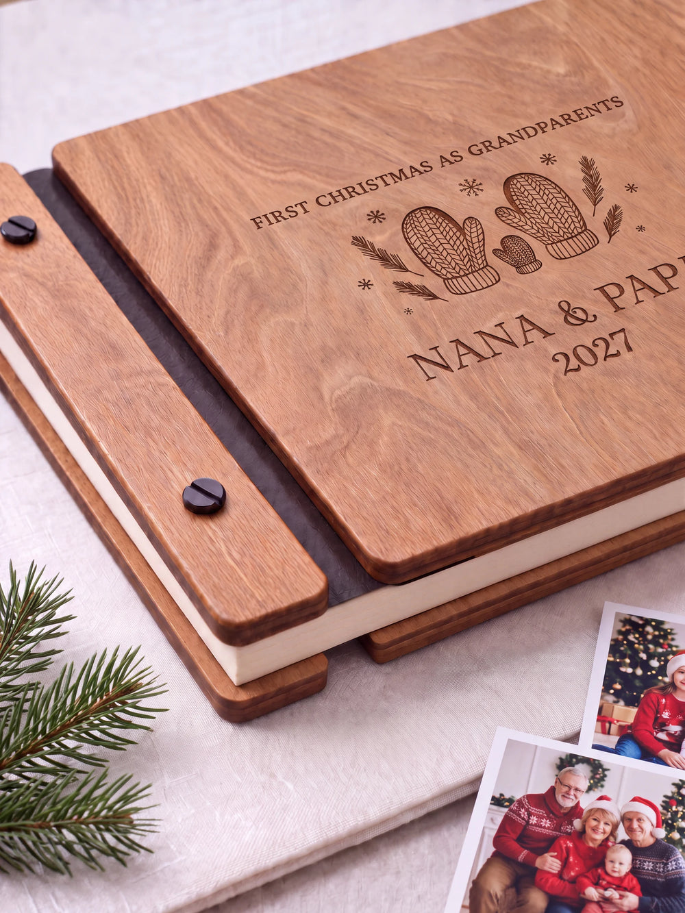 Close view of the Hazelnut album’s brown engraving, binding and black screw heads. Cream page edges and separate wooden cover sections are visible.