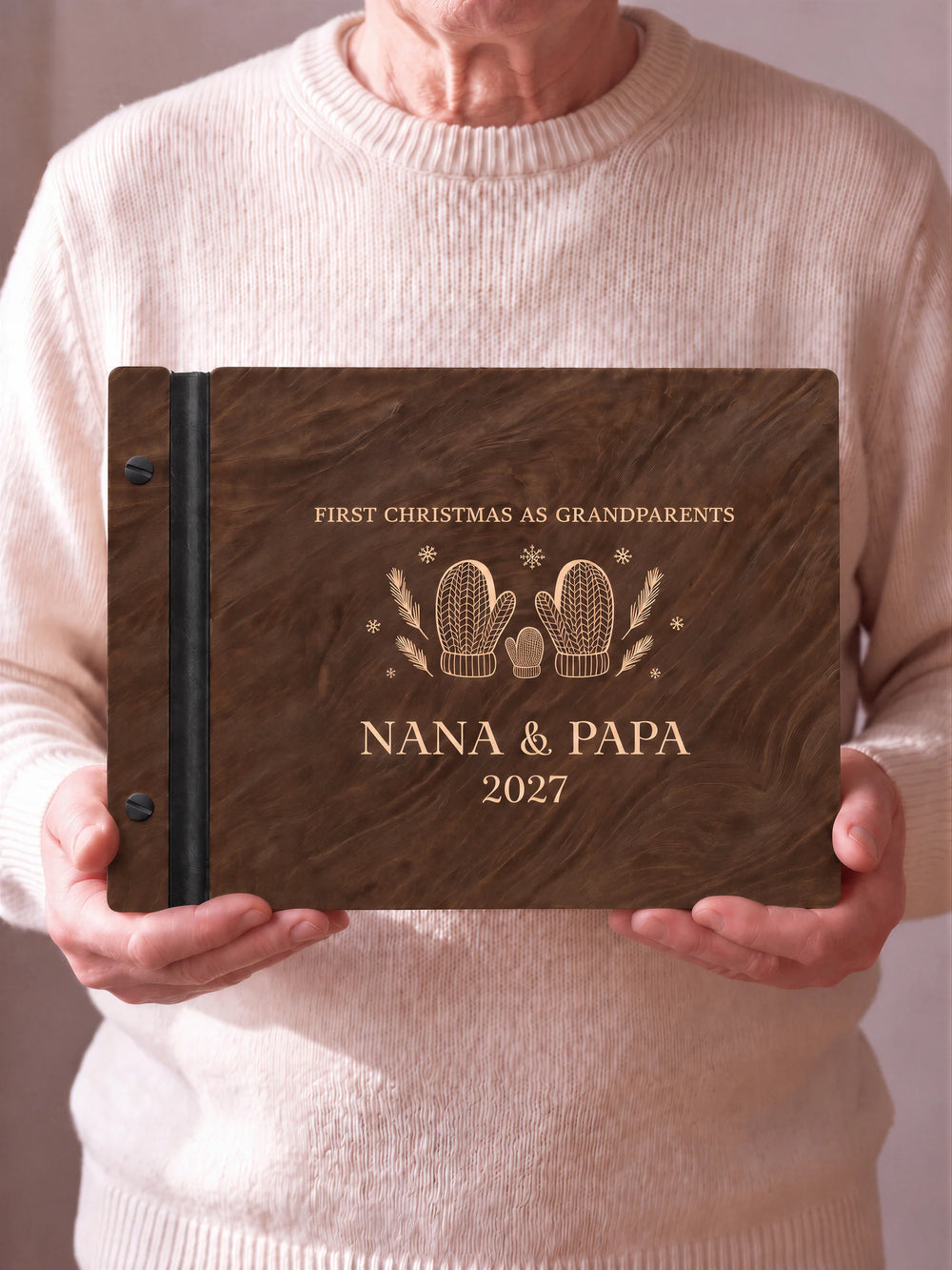 A close view of the dark brown Jacobean album and its cream laser-engraved FIRST CHRISTMAS AS GRANDPARENTS design, with black binding and matte black screws.