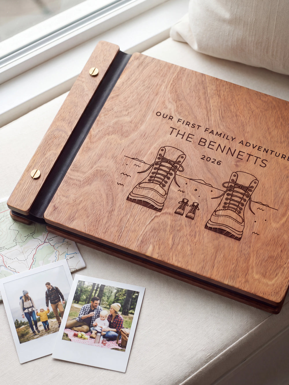 Close-up of adult and little hiking boots engraved in dark brown on the Hazelnut wooden cover, showing the fine artwork and surrounding wood grain.