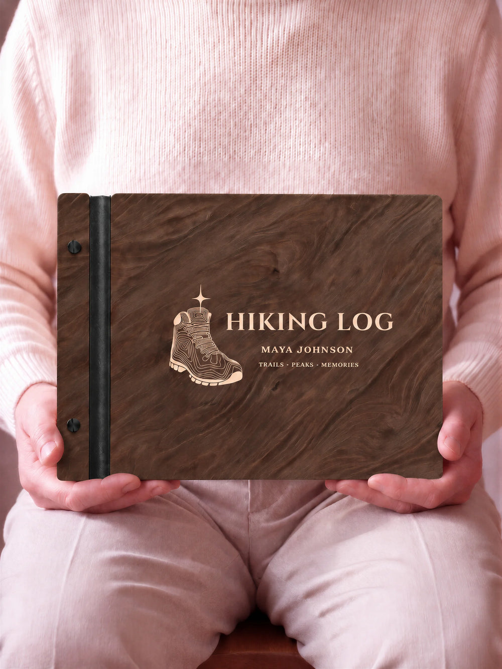 A close view of the dark brown Jacobean album and its cream laser-engraved HIKING LOG design, with black binding and matte black screws.
