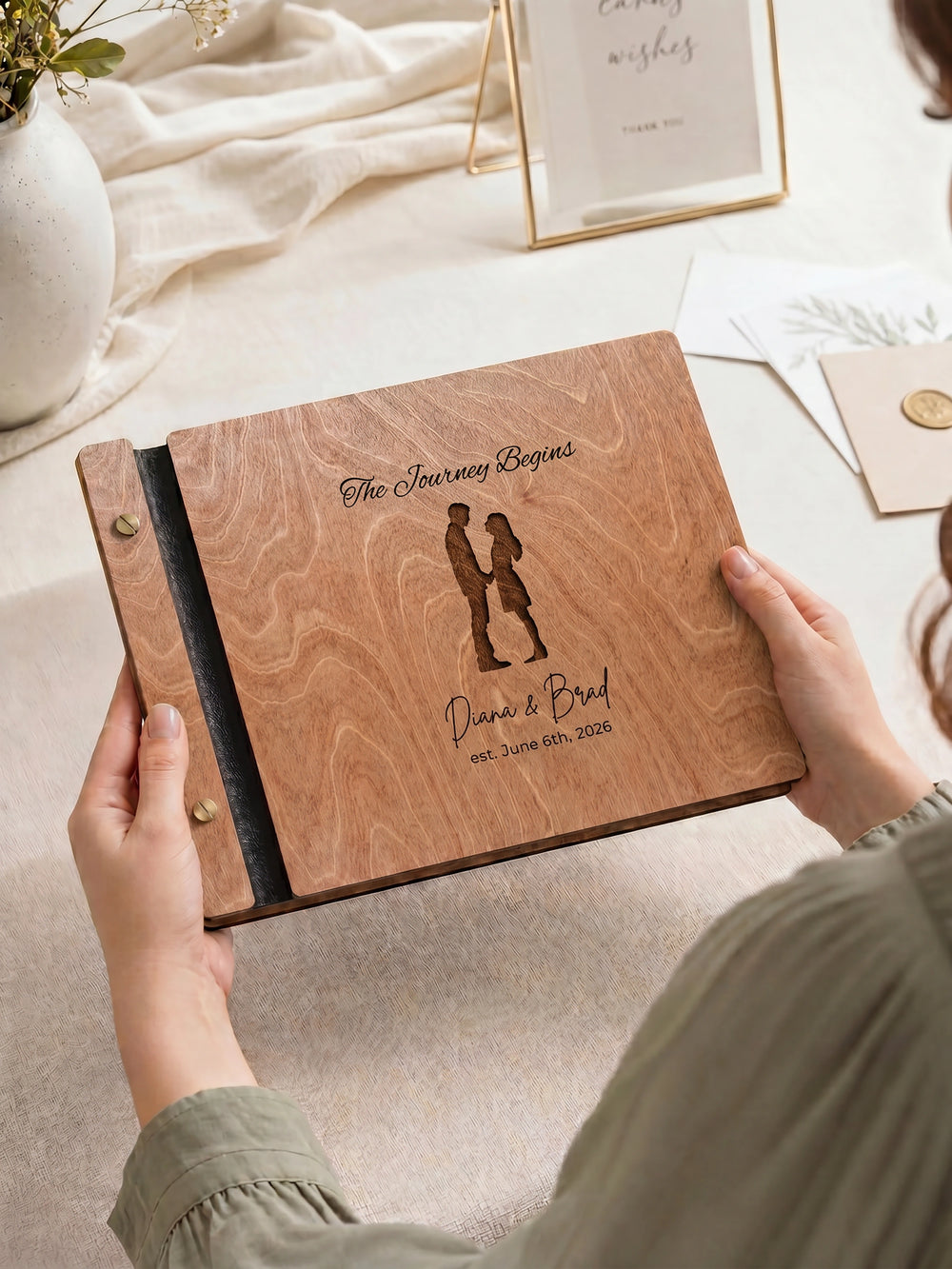 The Journey Begins photo guest book with a Hazelnut wood cover, vegan leather spine and screw posts