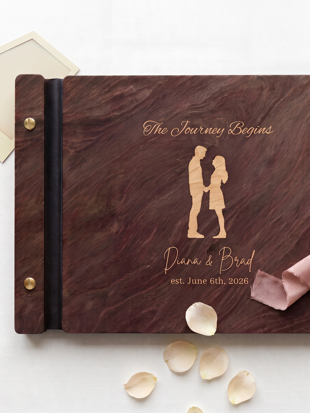 The Journey Begins photo guest book with a Jacobean wood cover, vegan leather spine and screw posts