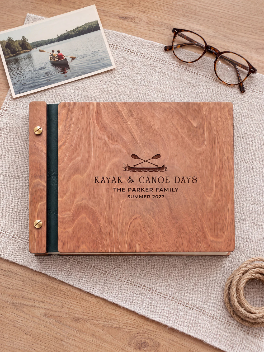 The full Hazelnut KAYAK & CANOE DAYS album cover is shown close up. Brown engraved artwork, personalized wording, the narrow binding and gold screws are visible.