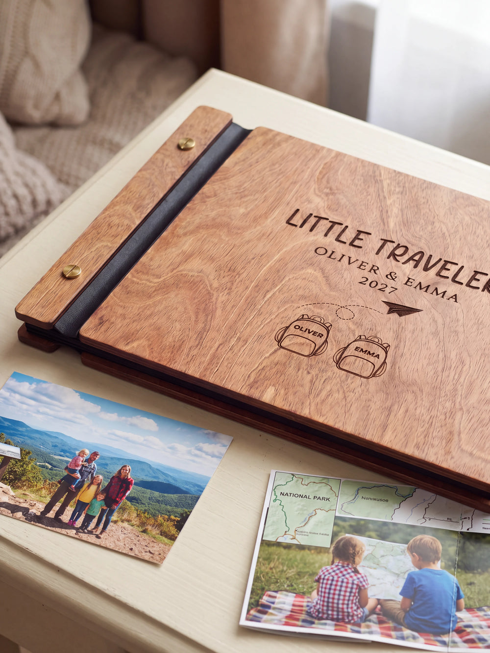 Close-up of two named backpacks and a paper airplane engraved in dark brown on the Hazelnut wooden cover, showing the fine artwork and surrounding wood grain.