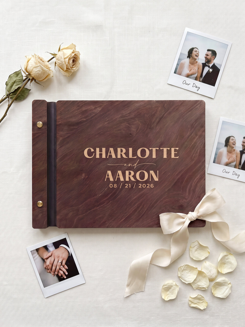 Hazelnut wood Charlotte and Aaron photo guest book on green fabric with instant photos, a brass pen and a compass