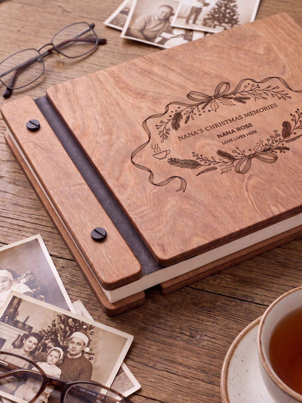 Close view of the Hazelnut album’s brown engraving, binding and black screw heads. Cream page edges and separate wooden cover sections are visible.