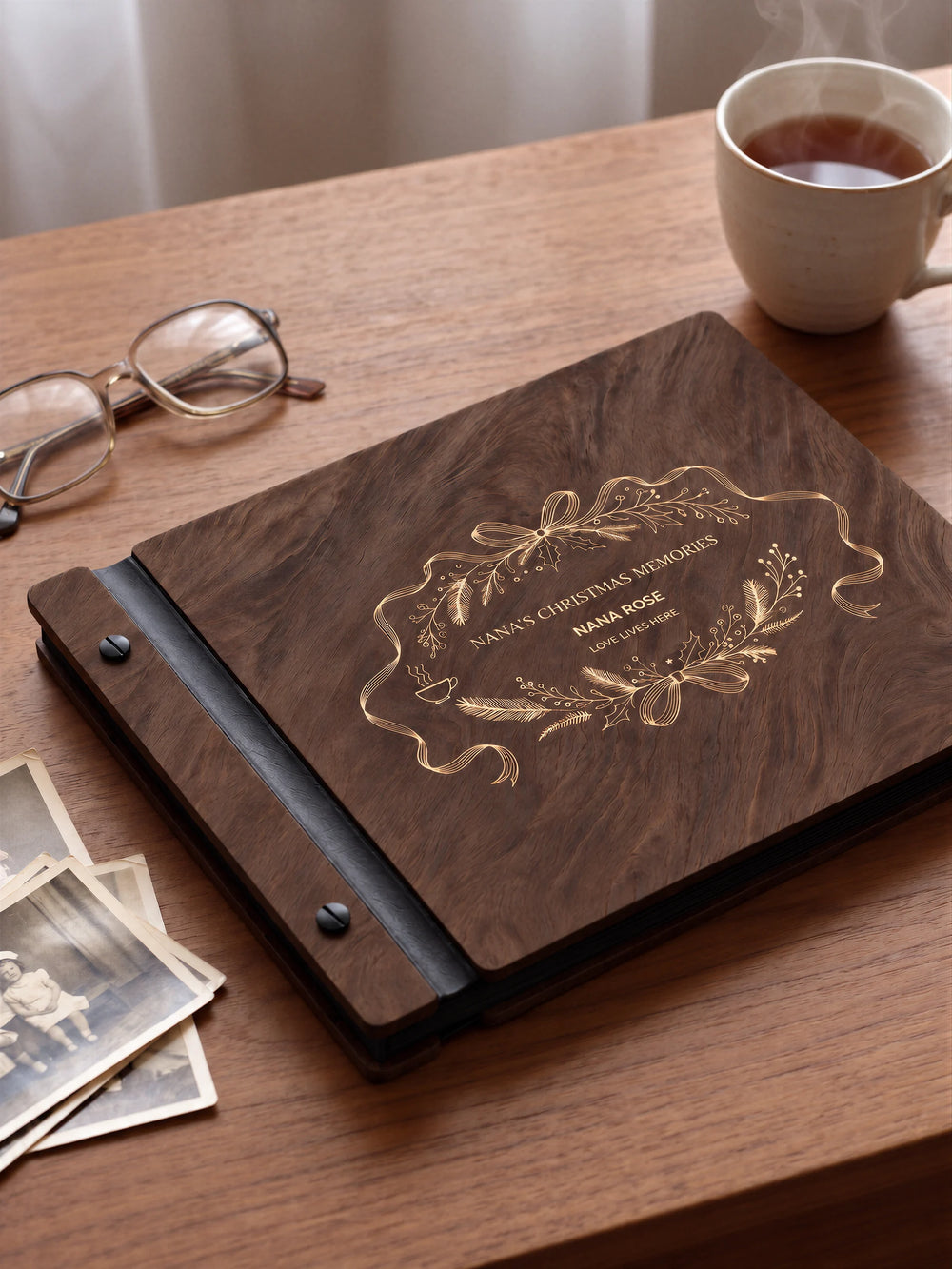 A close view of the dark brown Jacobean album and its cream laser-engraved NANA’S CHRISTMAS MEMORIES design, with black binding and matte black screws.