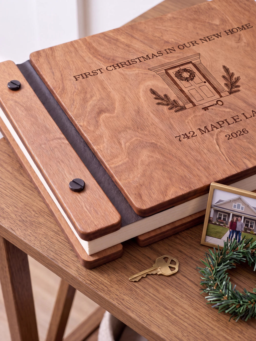 Close view of the Hazelnut album’s brown engraving, binding and black screw heads. Cream page edges and separate wooden cover sections are visible.