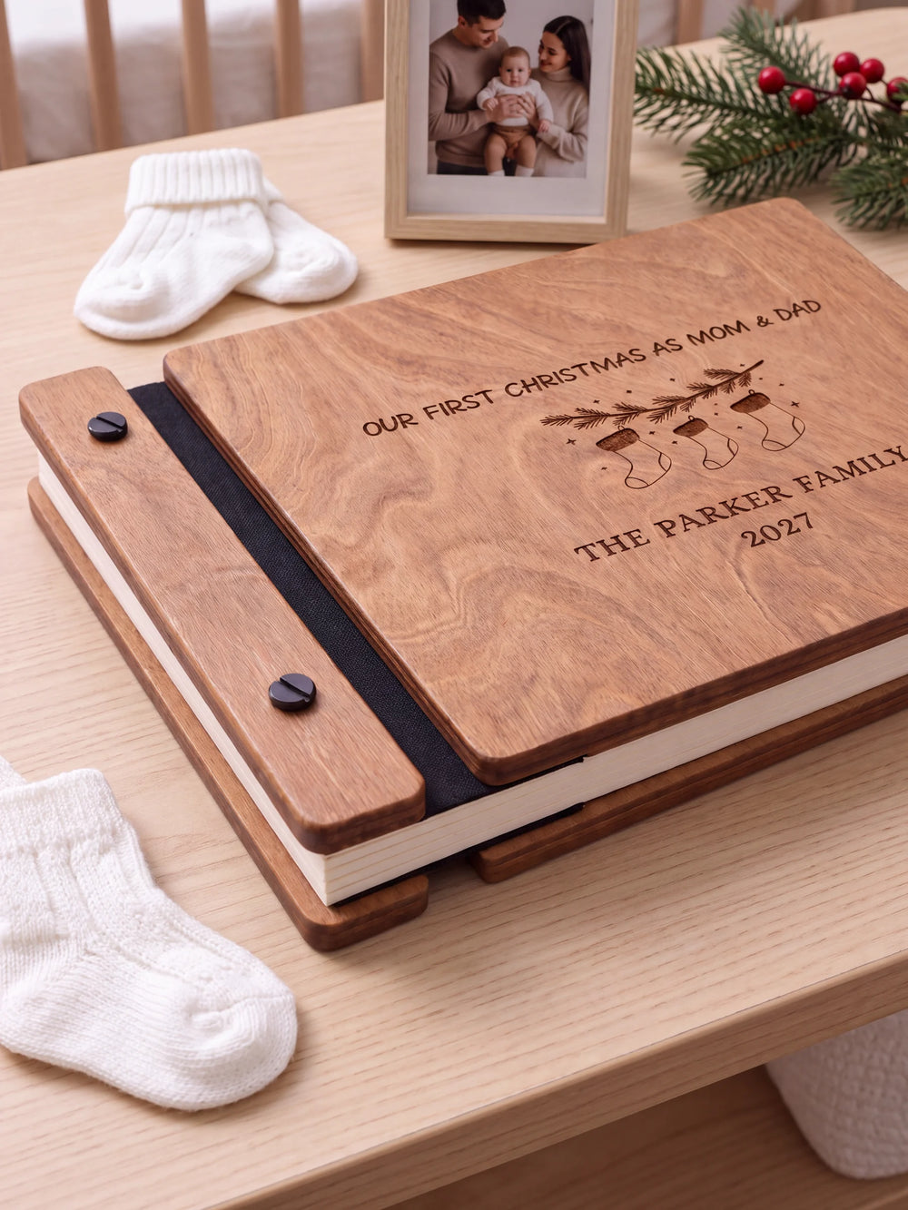 Close view of the Hazelnut album’s brown engraving, binding and black screw heads. Cream page edges and separate wooden cover sections are visible.