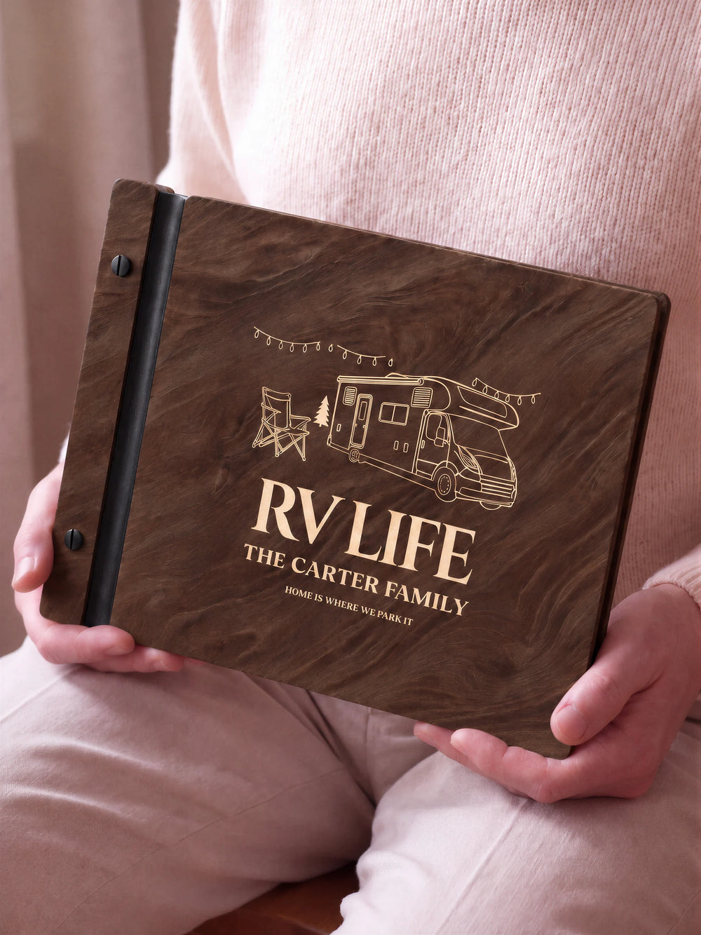 A close view of the dark brown Jacobean album and its cream laser-engraved RV LIFE design, with black binding and matte black screws.