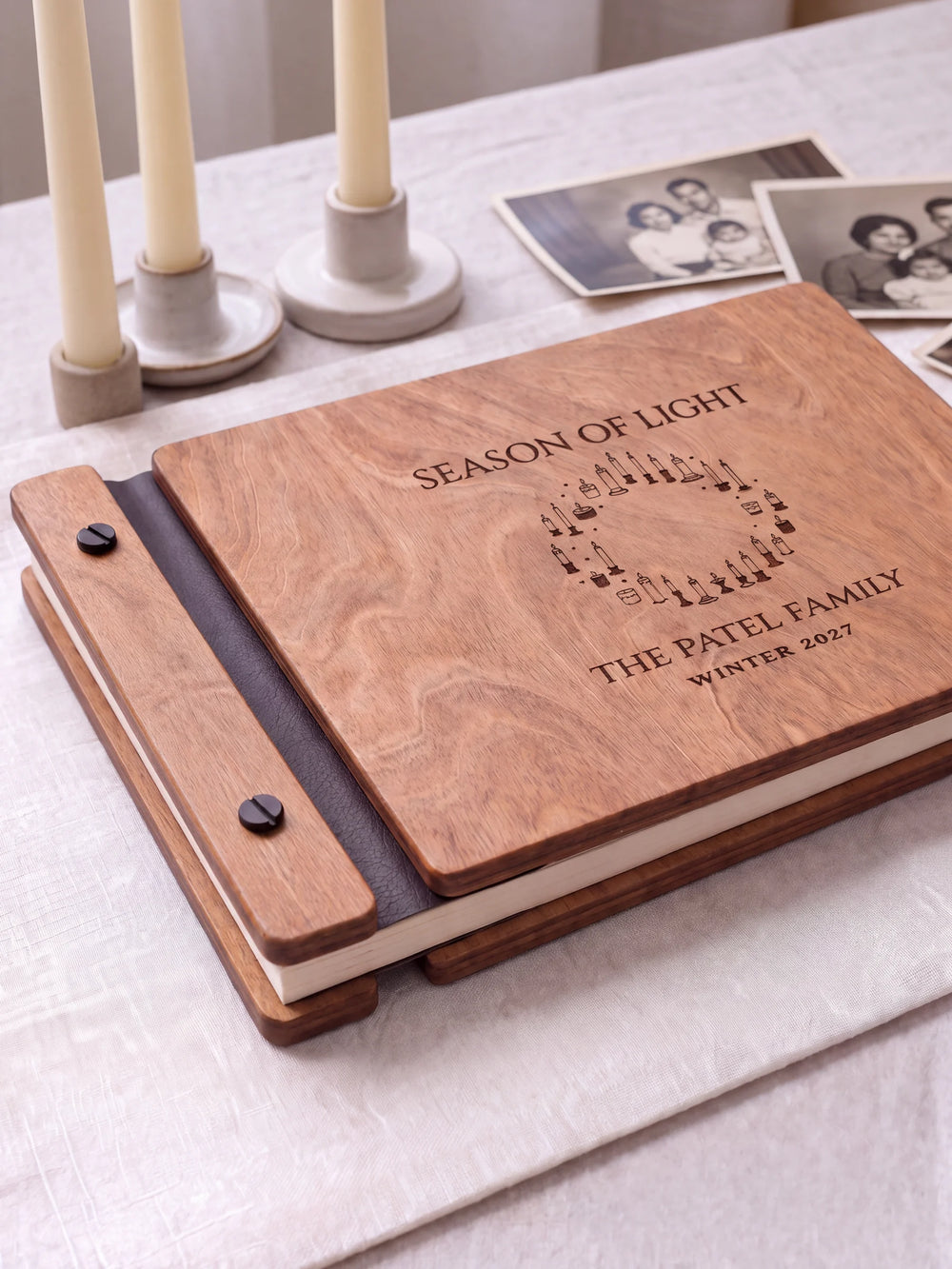 Close view of the Hazelnut album’s brown engraving, binding and black screw heads. Cream page edges and separate wooden cover sections are visible.