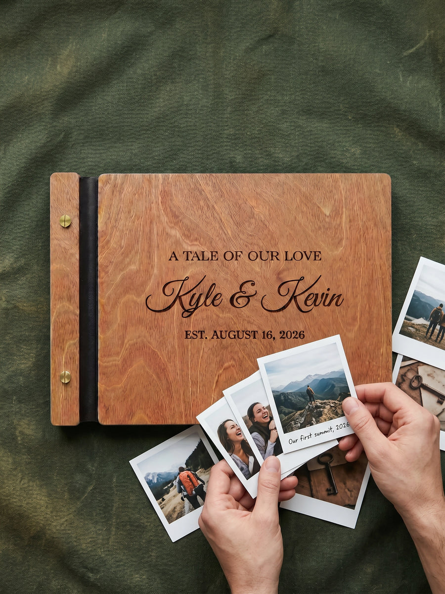 Hazelnut wood A Tale of Our Love photo guest book engraved Kyle & Kevin est. August 16, 2026, on green fabric with instant photos held in two hands