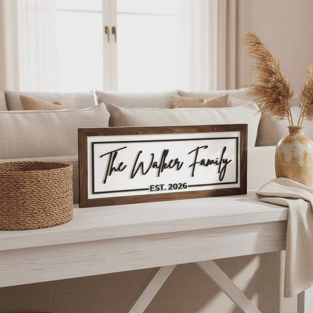 Short video of the personalized family name sign, The Walker Family Est. 2026, in a dark wood frame on a white console table.