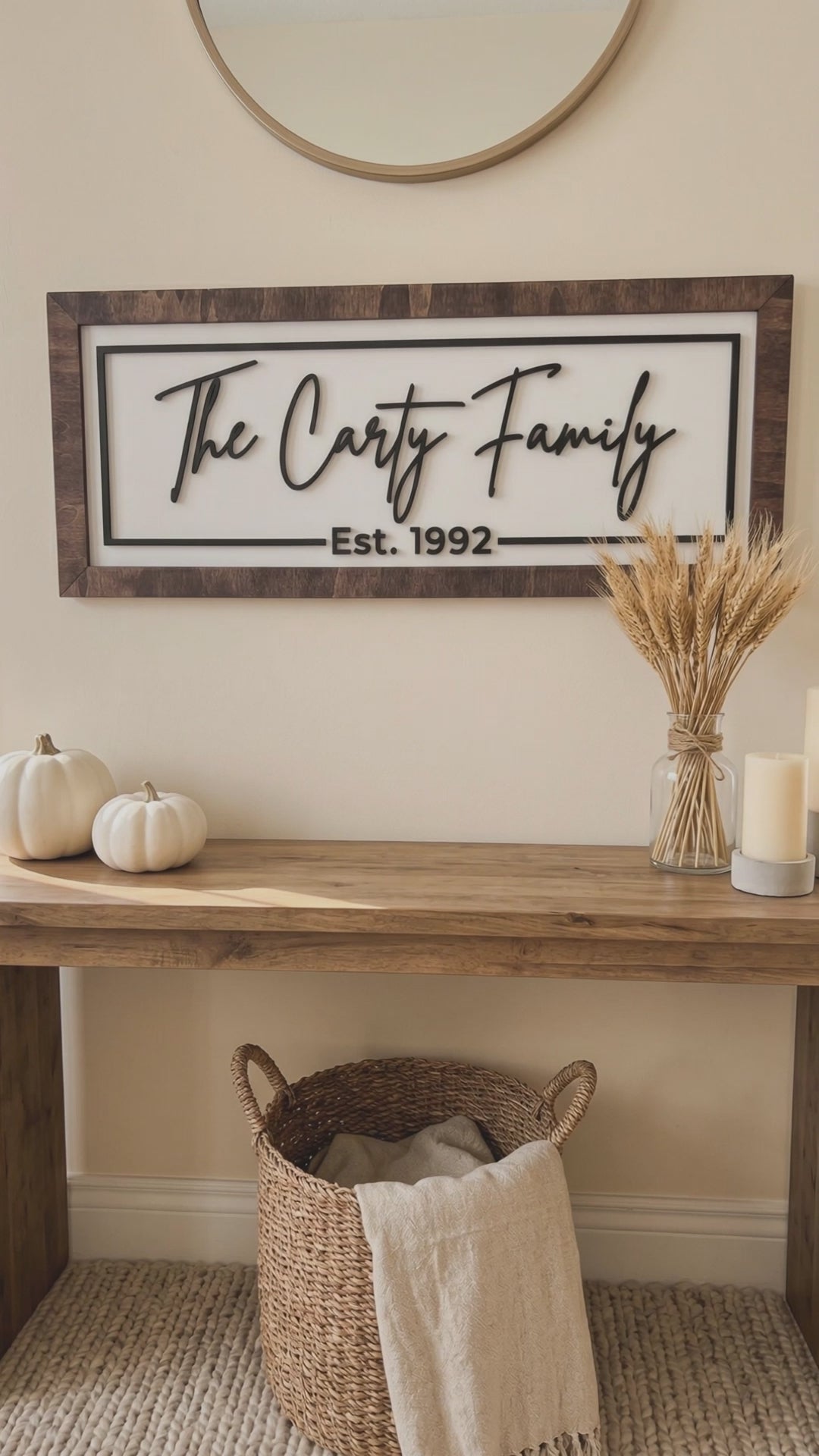 Short video of the framed family name sign, The Carty Family Est. 1992, above an entryway console with pumpkins and candles.